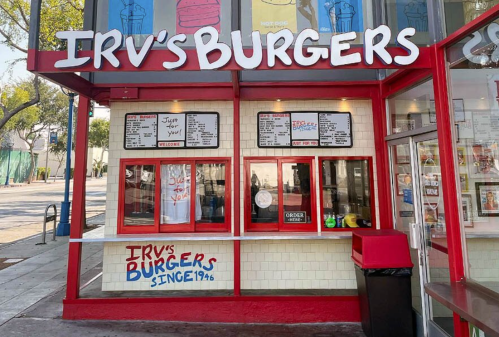 Exterior of Irv's Burgers, featuring a red and white color scheme, menu boards, and a takeout window.