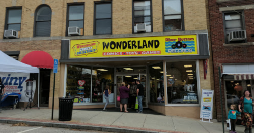 A storefront labeled "Wonderland Comics-Toys-Games" with people outside and a record store nearby.