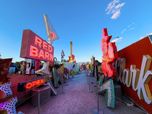 Colorful vintage neon signs in a desert landscape, creating a vibrant and eclectic atmosphere.