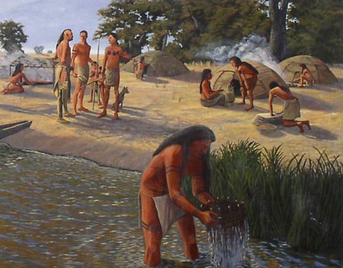 Indigenous people engaged in daily activities by a river, with huts and trees in the background.
