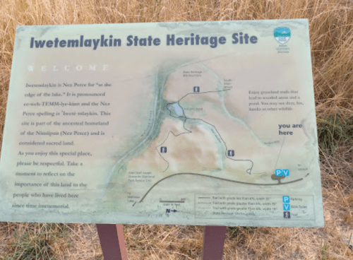 Sign at Iwetemlaykin State Heritage Site, welcoming visitors and providing a map of the area and its historical significance.