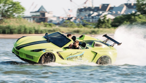 A bright green jet car splashes through water, with two people inside, showcasing a thrilling ride.