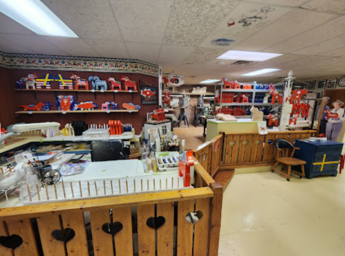 A colorful craft store interior with various tools, supplies, and displays on shelves and tables.