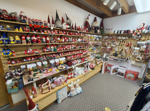 A cozy shop filled with various festive decorations, including gnomes, Santa figures, and holiday ornaments on display.