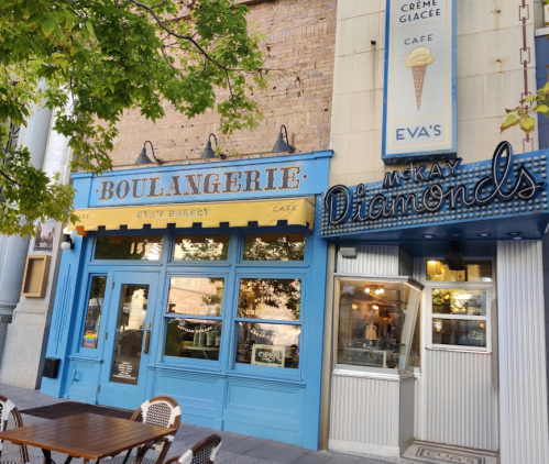 A blue bakery storefront labeled "Boulangerie" next to a shop named "McKay Diamonds," with outdoor seating visible.