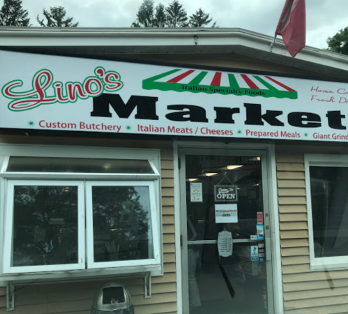 Exterior of Lino's Market, featuring a sign for Italian specialty foods, with a welcoming "Open" display.