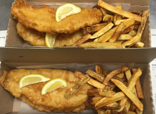 Two boxes of fried fish and chips, each with lemon wedges, served with golden-brown fries.