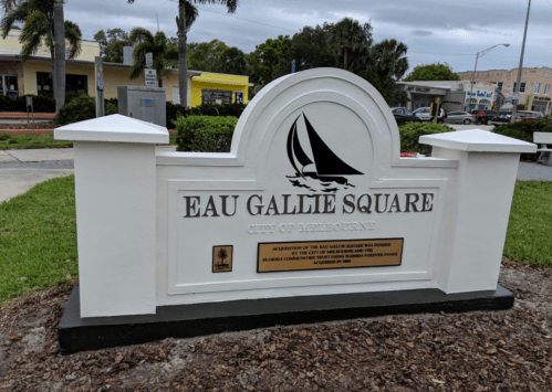 Sign for Eau Gallie Square in Melbourne, Florida, featuring a sailboat design and information about its establishment.
