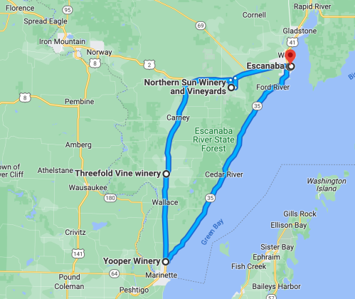 Map showing a route from Escanaba to various wineries, including Northern Sun Winery and Yooper Winery, in Michigan.