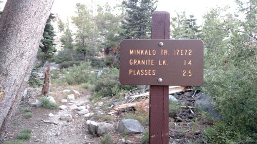 Trail sign indicating distances to Minko Trail (17.272 miles), Granite Lake (1.4 miles), and Plasses (2.5 miles).