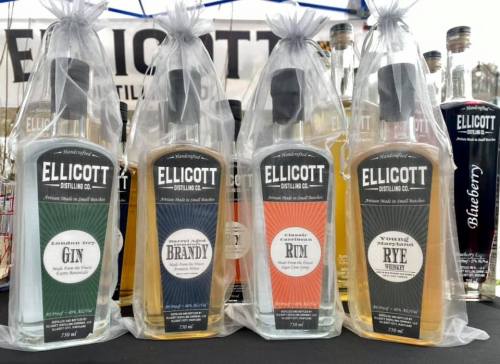 Four bottles of Ellicott Distilling Co. spirits, including gin, brandy, rum, and rye, displayed in clear packaging.