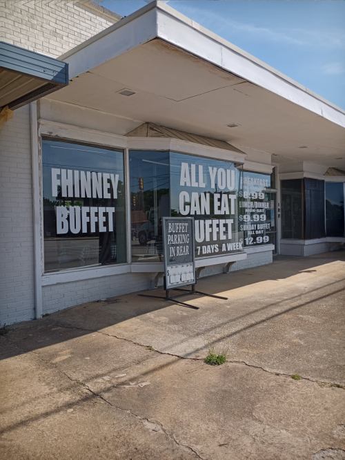 Signage for "Finney Buffet" advertising an all-you-can-eat buffet, open seven days a week, with prices listed.