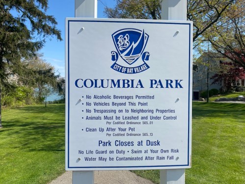 Sign at Columbia Park listing rules: no alcohol, no vehicles, leash pets, clean up after them, park closes at dusk.