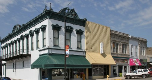Historic storefronts along small town in Missouri under a blue sky