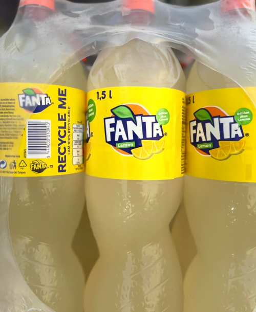 Three bottles of Fanta Lemon, 1.5 liters each, packaged together with a label that says "Recycle Me."