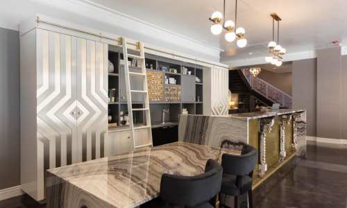 Modern hotel lobby with a stylish bar, elegant lighting, and a unique patterned countertop.