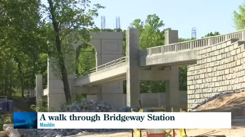Construction of a bridge at Bridgeway Station, surrounded by trees and building materials.
