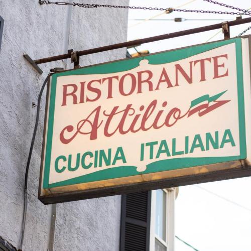 Sign for "Ristorante Attilio" featuring the words "Cucina Italiana" in a classic Italian restaurant style.