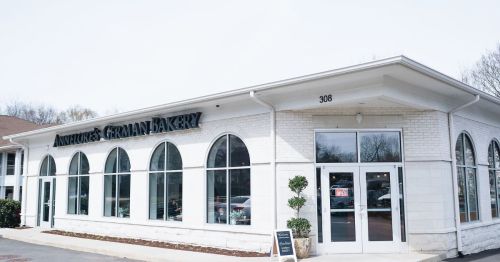 Exterior of Annette's German Bakery, featuring large arched windows and a welcoming entrance.