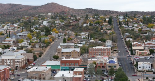 aerial of downtown glove, arizona with mountains in the background