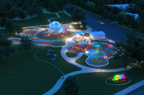 Aerial view of a vibrant park at night, featuring colorful play areas, a dome structure, and illuminated pathways.