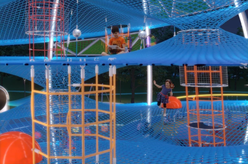 Two children play on a colorful, elevated net structure in a park, surrounded by vibrant lights and playful designs.
