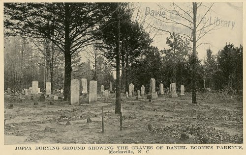 Graves of Daniel Boone's parents in Joppa Burying Ground, Mocksville, NC, surrounded by trees and headstones.