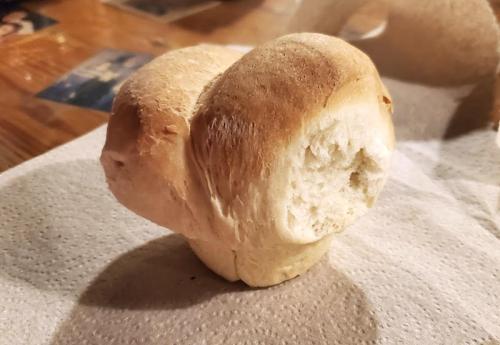 A uniquely shaped piece of bread resembling a mushroom, resting on a paper towel.