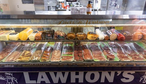 A display case filled with various meats and cheeses, labeled with "Dietz & Watson" and "Lawhon's."