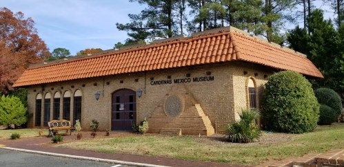 Exterior of the Cardenas Mexico Museum, featuring a brick building with a tiled roof and landscaped surroundings.