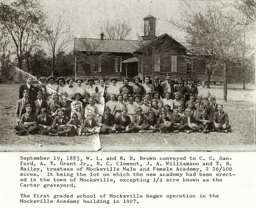 Historic photo from 1885 showing a large group of people in front of a school building in Mocksville, NC.
