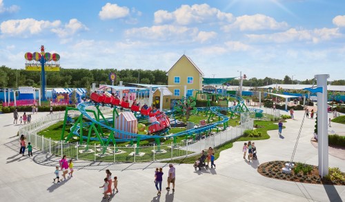 A colorful amusement park scene with a roller coaster, attractions, and visitors enjoying a sunny day.