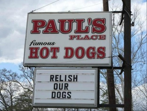 Sign for Paul's Place featuring "Famous Hot Dogs" and a playful message: "Relish Our Dogs."