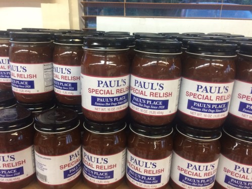 A stack of jars labeled "Paul's Special Relish" from Paul's Place, featuring a red and white design.