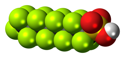 3D molecular structure showing a chain of green spheres with red and white spheres representing different atoms.