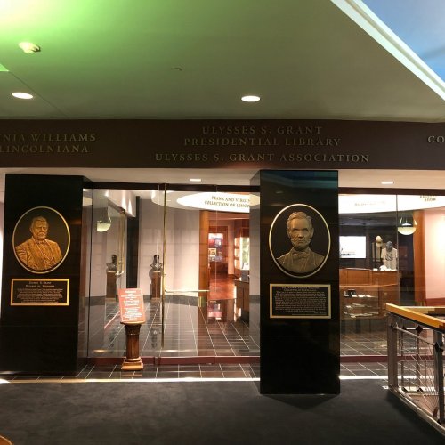Entrance to the Ulysses S. Grant Presidential Library, featuring plaques of notable figures and a welcoming atmosphere.