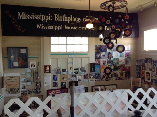 Interior view of the Mississippi Musicians Hall of Fame, featuring a banner and various photos and memorabilia on display.