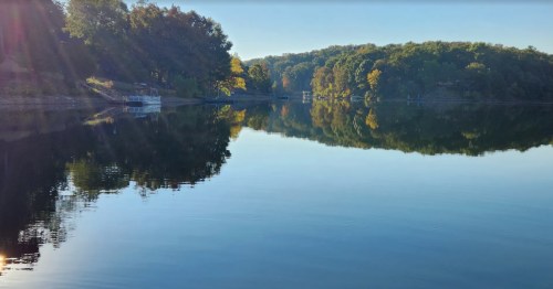Beautiful Brittany Dam in Arkansas under a bright blue sky.