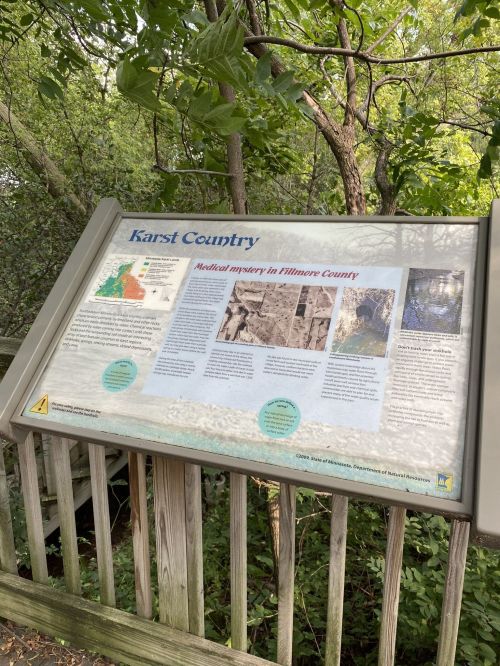 Information sign about Karst Country in Fillmore County, featuring maps and text on geological features and history.