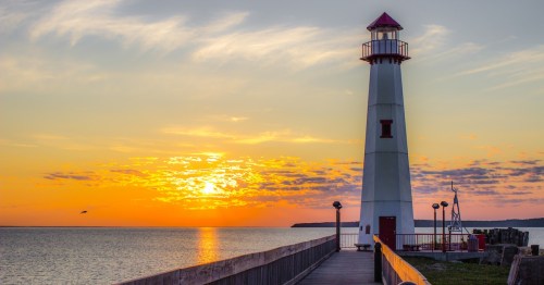 St. Ignace, Michigan, lighthouse as the sun rises over Lake Huron.