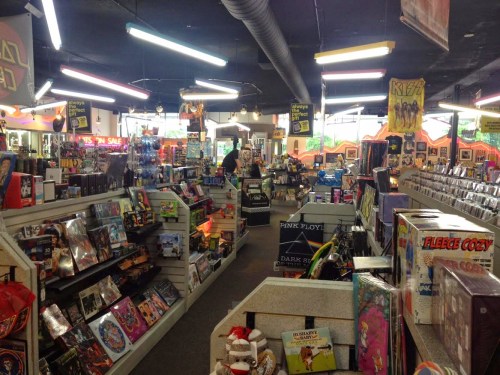 A vibrant record store interior filled with shelves of vinyl, merchandise, and colorful displays.