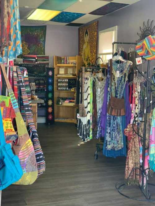 A colorful boutique interior featuring vibrant clothing, bags, and decor, with racks and shelves displaying various items.