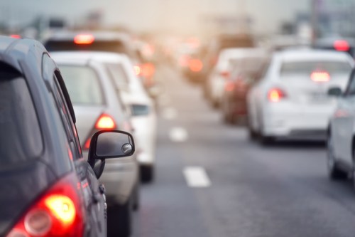 Traffic jam with multiple cars on a busy road, brake lights glowing in the distance.