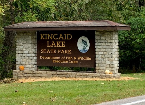 Sign for Kincaid Lake State Park, featuring a stone structure and information about the Department of Fish & Wildlife.