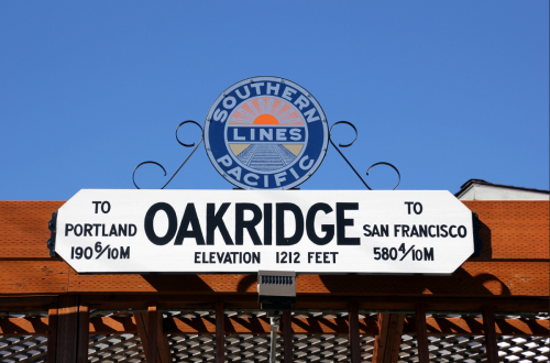 Sign for Southern Pacific Lines indicating directions to Portland and San Francisco, with elevation for Oakridge.