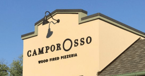 Sign for Camporosso Wood Fired Pizzeria, featuring a light fixture and a clear blue sky in the background.