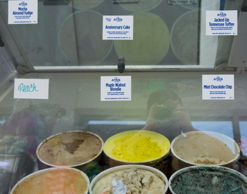 Ice cream display with flavors: Peach, Mocha Almond Fudge, Anniversary Cake, Maple Walnut Blondie, Jacked Up Tennessee Toffee, Mint Chocolate Chip.