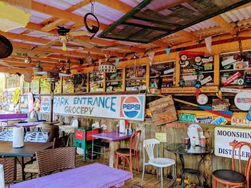 Colorful interior of a rustic restaurant with wooden tables, vintage signs, and a welcoming atmosphere.