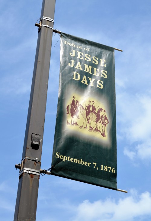 Banner for "Defeat of Jesse James Days," dated September 7, 1876, against a blue sky background.