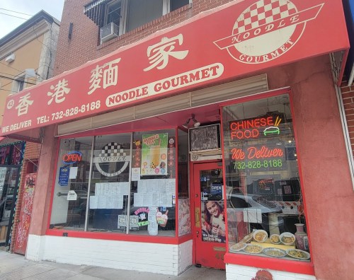 A red storefront of "Noodle Gourmet" featuring a menu, neon signs, and a delivery phone number.